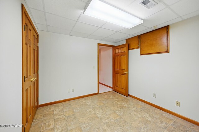4860 Wenatchi Trl, Lima, OH 45805 - empty room featuring a drop ceiling and stone finish floors