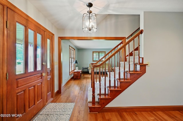 4860 Wenatchi Trl, Lima, OH 45805 - foyer with stairs, wood finished floors, and a chandelier