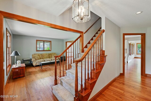4860 Wenatchi Trl, Lima, OH 45805 - stairway featuring hardwood / wood-style floors, a chandelier, and recessed lighting