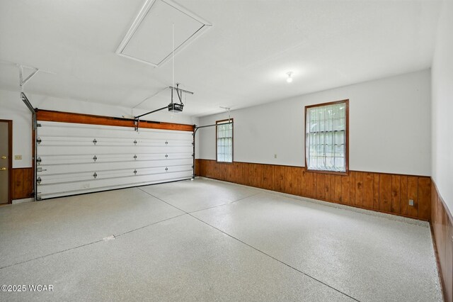 4860 Wenatchi Trl, Lima, OH 45805 - garage featuring a wainscoted wall, a garage door opener, and wood walls