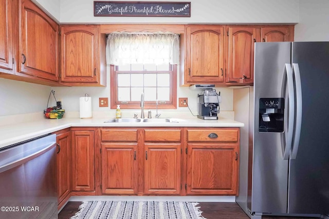 16070 Rd S, Columbus Grove, OH 45830 - kitchen with appliances with stainless steel finishes, a sink, brown cabinetry, and light countertops