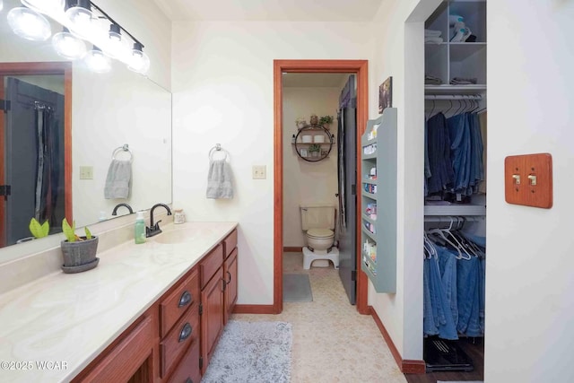 16070 Rd S, Columbus Grove, OH 45830 - full bathroom with vanity, toilet, baseboards, and a walk in closet