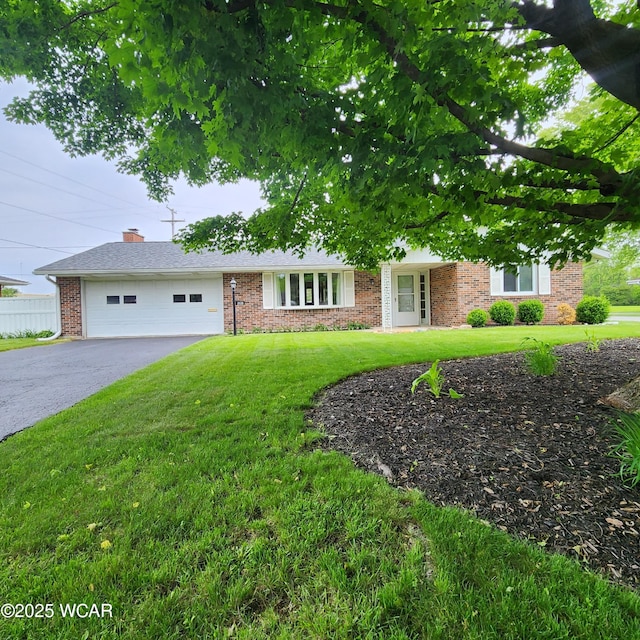 2028 Greendale Ave, Findlay, OH 45840 - view of front of home featuring asphalt driveway, brick siding, and an attached garage