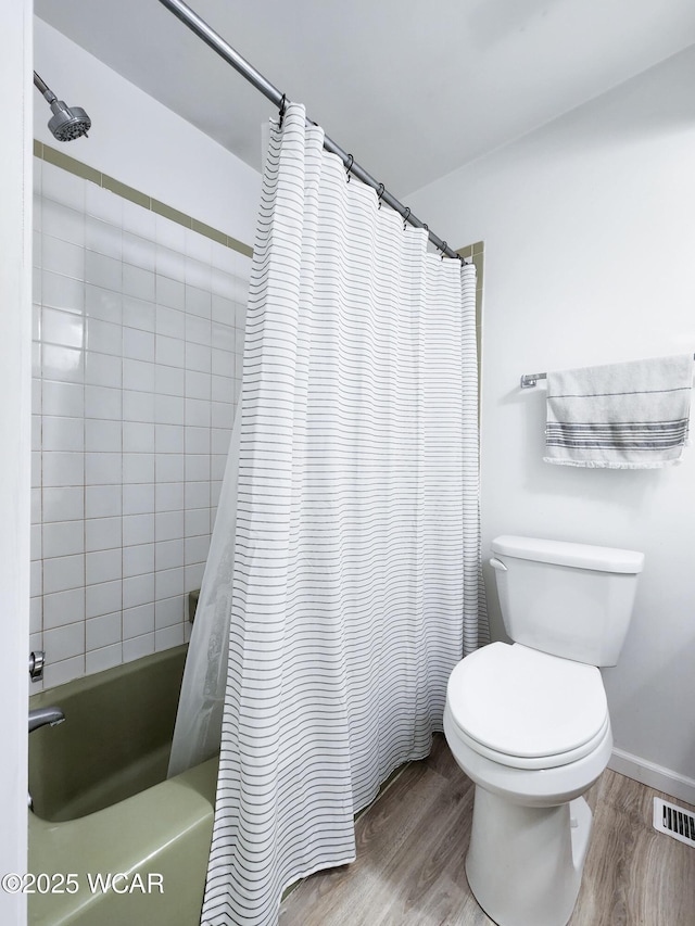2028 Greendale Ave, Findlay, OH 45840 - bathroom with wood finished floors, shower / bath combo, and toilet