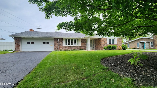 2028 Greendale Ave, Findlay, OH 45840 - ranch-style home with a garage, driveway, and brick siding