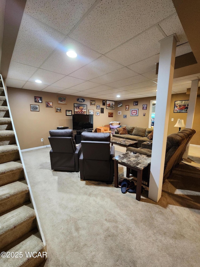 carpeted living area with stairway, recessed lighting, baseboards, and a drop ceiling