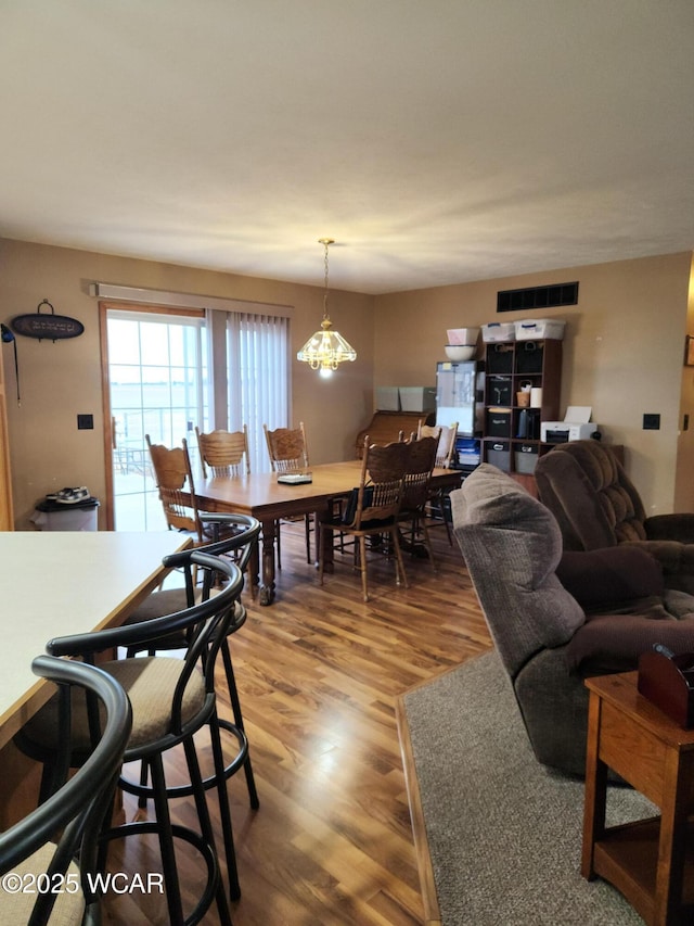 living room with visible vents and wood finished floors