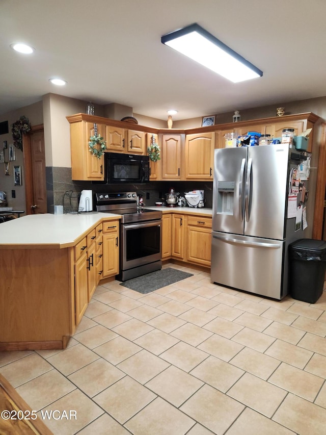 kitchen featuring a peninsula, recessed lighting, stainless steel appliances, light countertops, and tasteful backsplash