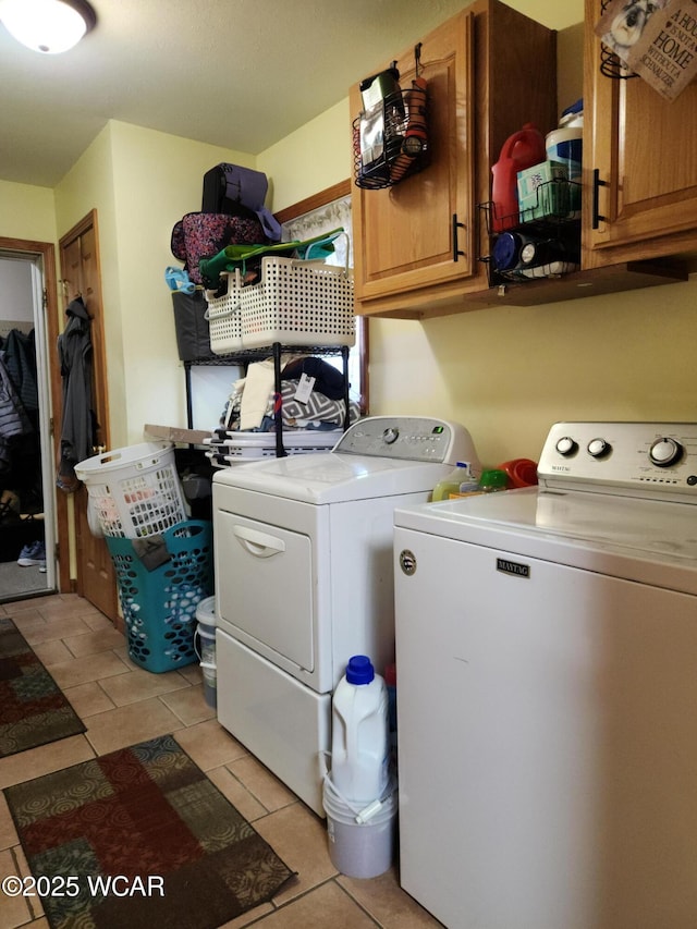 clothes washing area with cabinet space and independent washer and dryer