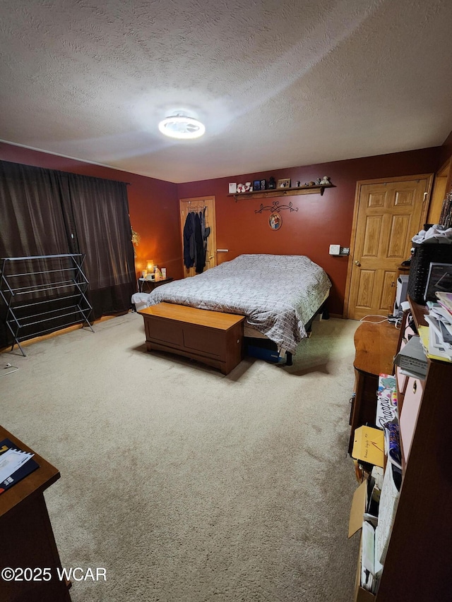 carpeted bedroom featuring a textured ceiling