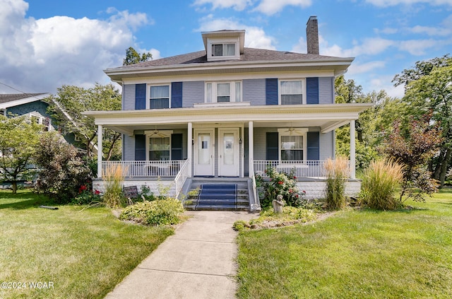 view of front of property featuring a front lawn and covered porch