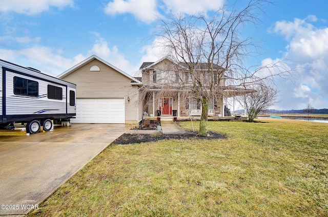 view of front of property featuring a garage, a front lawn, and a water view