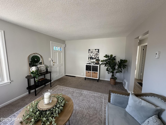 living room featuring visible vents, baseboards, and carpet