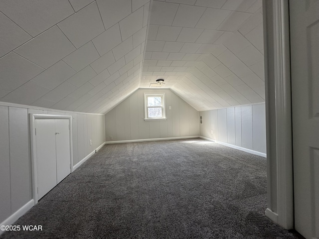 bonus room featuring lofted ceiling and carpet flooring