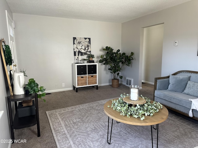 carpeted living area with visible vents, a textured ceiling, and baseboards