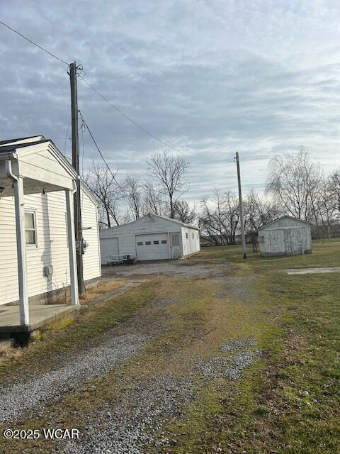 view of yard with a garage and an outdoor structure