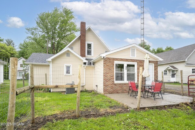 247 W State St, West Mansfield, OH 43358 - back of property featuring a patio area, a chimney, central AC unit, and brick siding