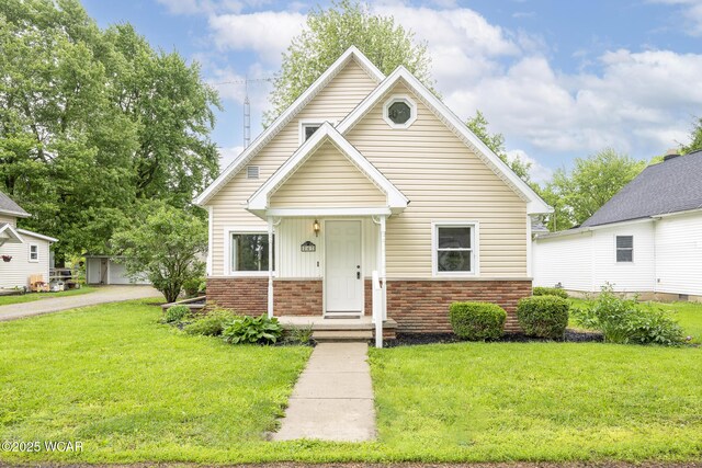 247 W State St, West Mansfield, OH 43358 - bungalow-style house featuring brick siding and a front yard