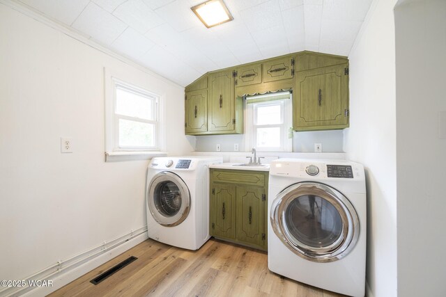 247 W State St, West Mansfield, OH 43358 - laundry room featuring cabinet space, washer and dryer, light wood-style flooring, and crown molding