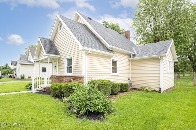 247 W State St, West Mansfield, OH 43358 - view of front of house with roof with shingles, a front yard, and a chimney