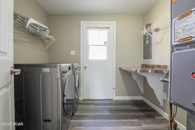 laundry room with washer and dryer and dark wood-type flooring