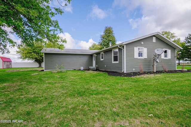 rear view of property featuring a yard