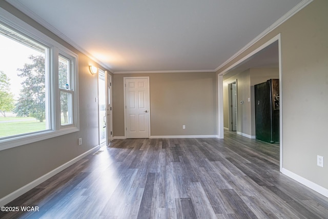 empty room with ornamental molding and dark wood-type flooring