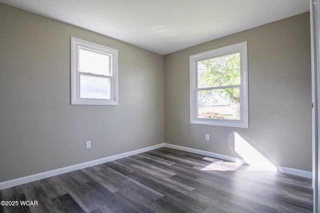 spare room with dark hardwood / wood-style floors