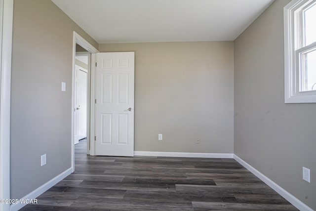 empty room featuring dark wood-type flooring