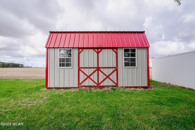 view of outdoor structure featuring a lawn