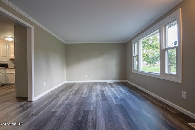 spare room featuring crown molding and dark hardwood / wood-style floors