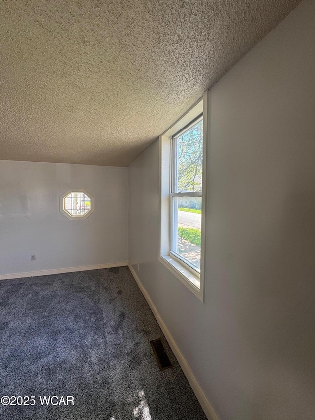 512 W N St, Kenton, OH 43326 - empty room featuring a textured ceiling, carpet floors, and baseboards