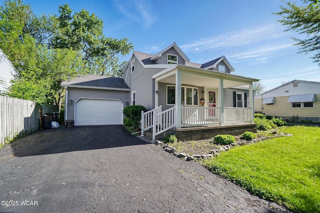 2432 Kunneke Ave, Lima, OH 45805 - bungalow-style home featuring covered porch, asphalt driveway, an attached garage, a shingled roof, and a front yard