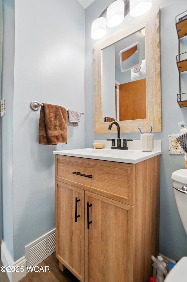2432 Kunneke Ave, Lima, OH 45805 - half bathroom featuring toilet, vanity, and baseboards