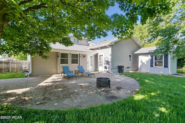 2432 Kunneke Ave, Lima, OH 45805 - rear view of house featuring a patio, an outdoor fire pit, a shingled roof, and an outdoor structure