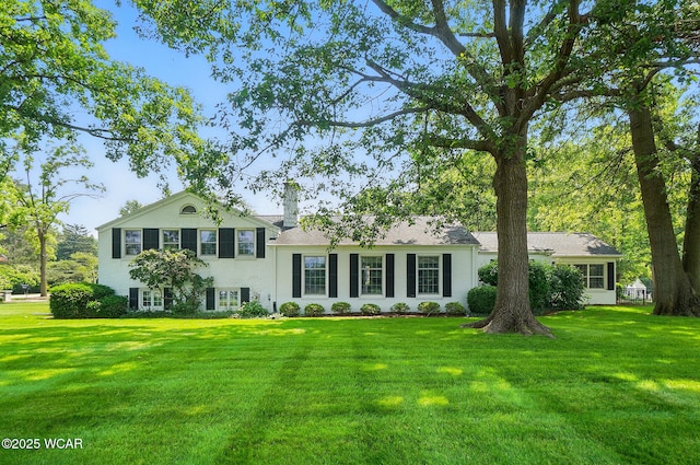 2297 June Dr, Lima, OH 45805 - tri-level home featuring a front yard and a chimney