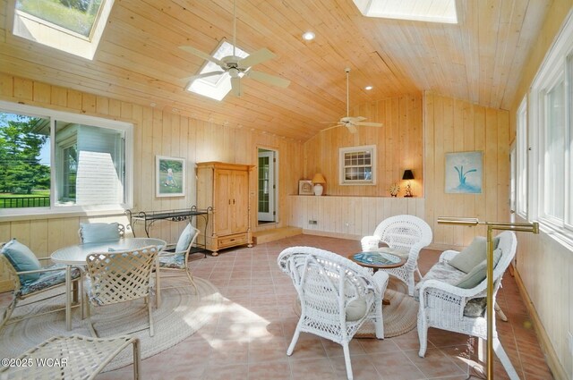 2297 June Dr, Lima, OH 45805 - living area with a skylight, vaulted ceiling, wooden walls, light tile patterned floors, and wood ceiling