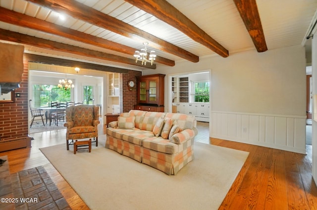 2297 June Dr, Lima, OH 45805 - living area with a chandelier, hardwood / wood-style floors, healthy amount of natural light, a wainscoted wall, and beamed ceiling