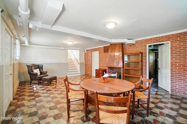 2297 June Dr, Lima, OH 45805 - dining space with brick wall and stairway