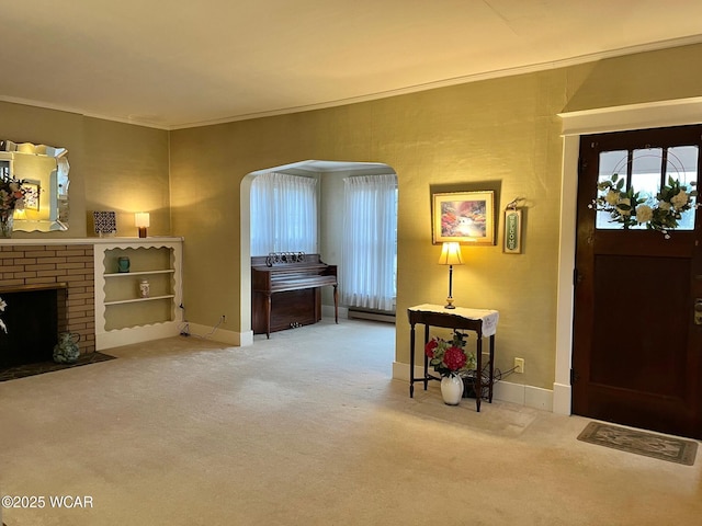 entryway featuring ornamental molding, carpet floors, and a brick fireplace