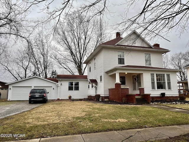 view of front of property featuring a garage, an outdoor structure, covered porch, and a front lawn