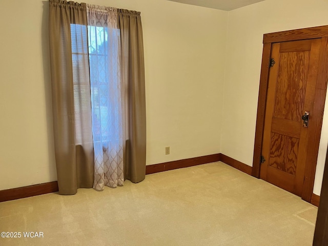 unfurnished room featuring light colored carpet