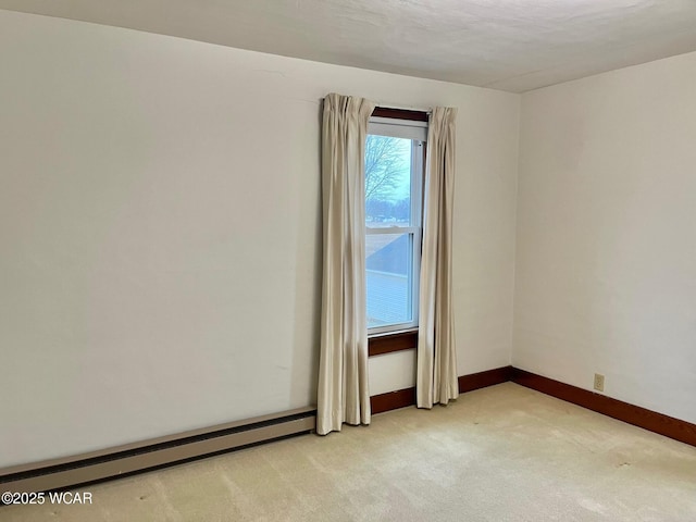 carpeted empty room with a baseboard heating unit