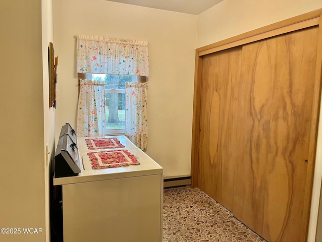 clothes washing area featuring a baseboard heating unit