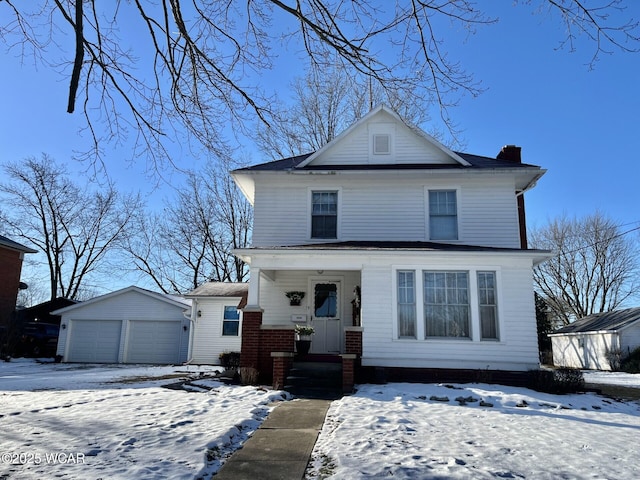 view of front of property featuring a garage and an outdoor structure