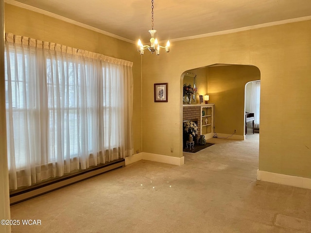 empty room with a chandelier, a baseboard radiator, ornamental molding, carpet floors, and a fireplace