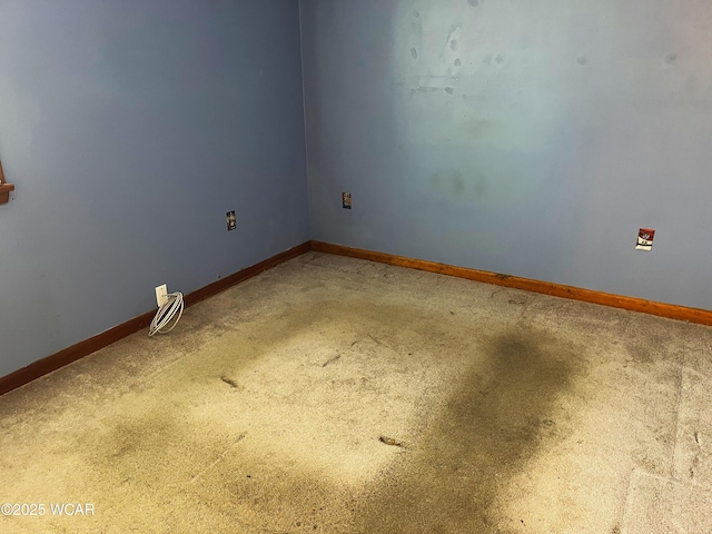 spare room with carpet and baseboards