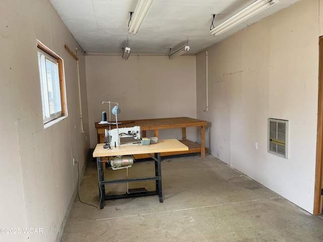 basement with a workshop area and heating unit