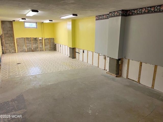 basement featuring a textured ceiling