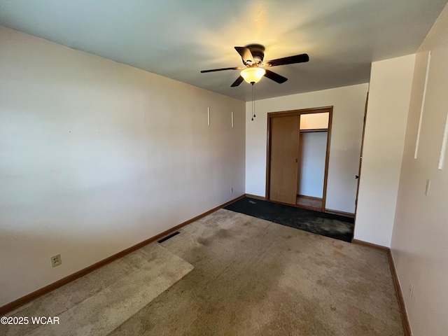 unfurnished bedroom with baseboards, visible vents, ceiling fan, carpet floors, and a closet